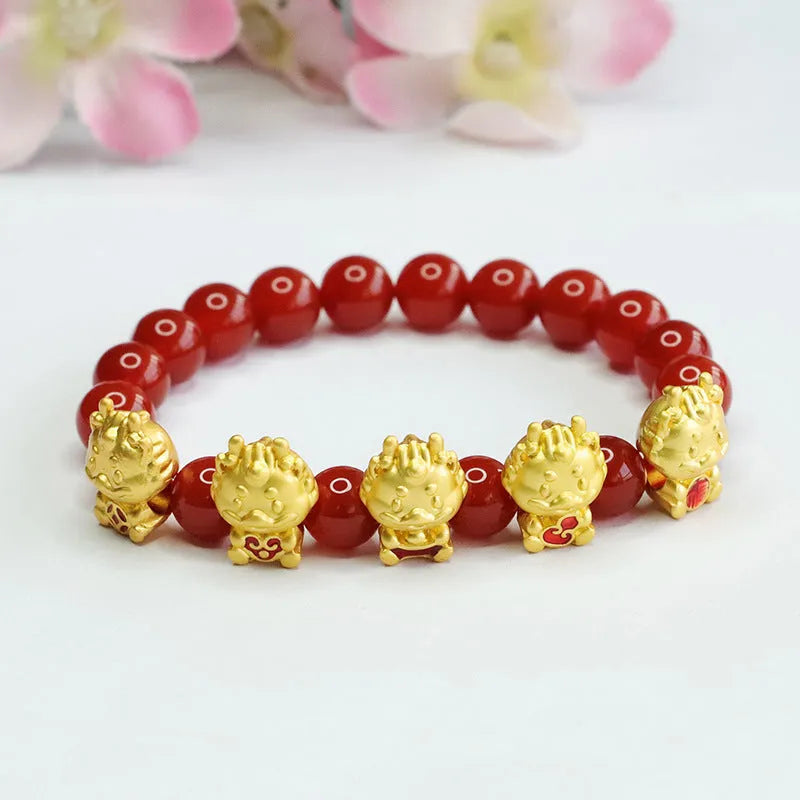 Natural red agate bead bracelet with a detailed five blessings dragon charm on a white background.