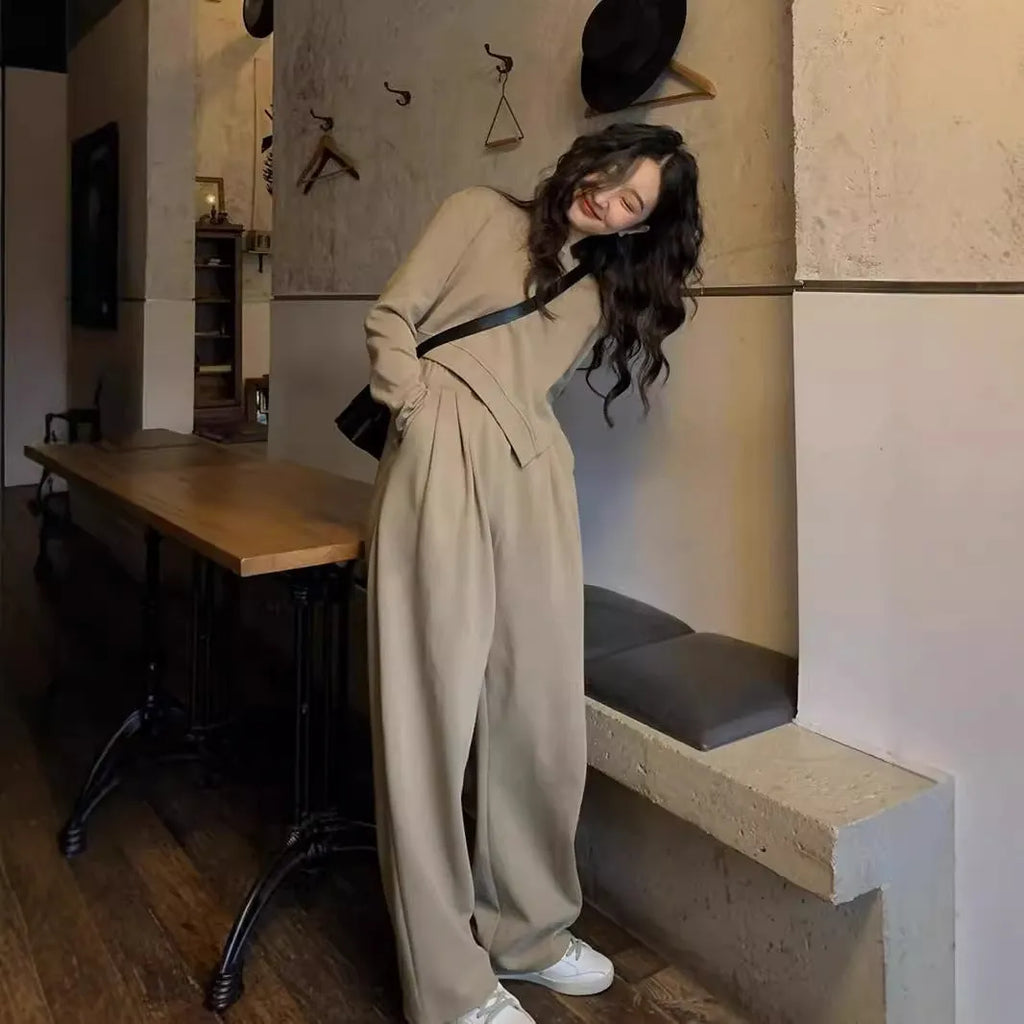 Women's brown loose-fit casual sports suit with long sleeves and full-length trousers on a hanger.