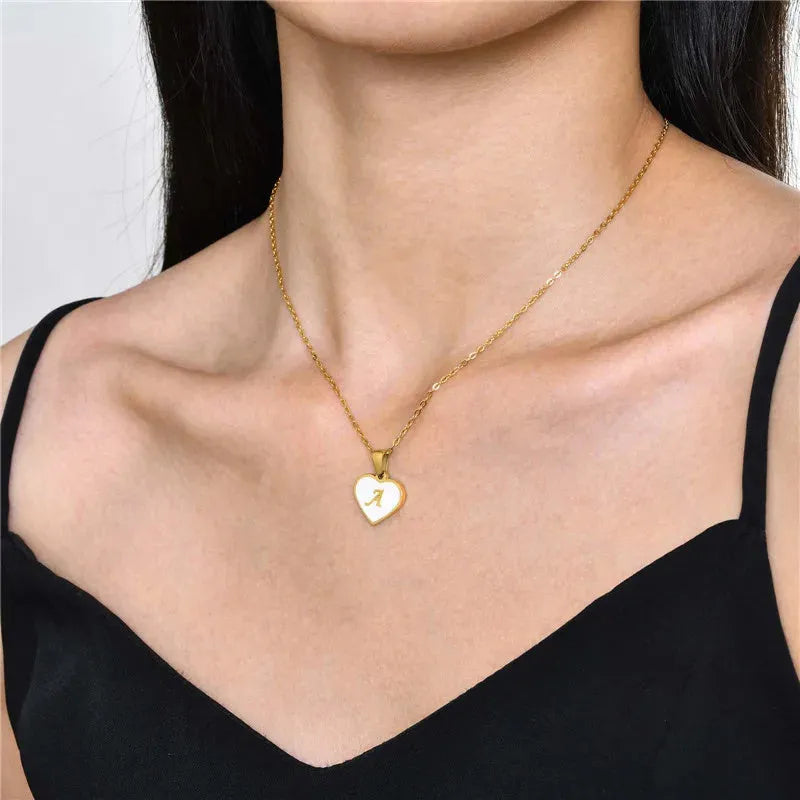Gold plated initial necklace with white shell heart pendant and adjustable chain