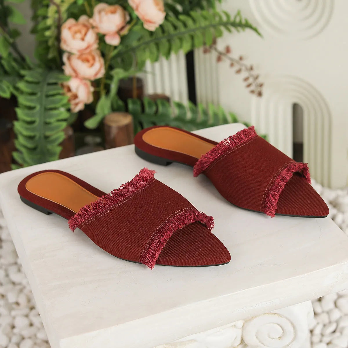 Women's denim flat slippers with tassel detail and leather lining in apricot colour.