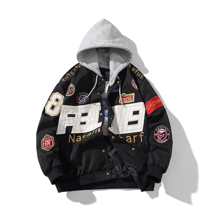 Man wearing a black motorcycle-style baseball jacket with a removable hood, featuring a side seam pocket.