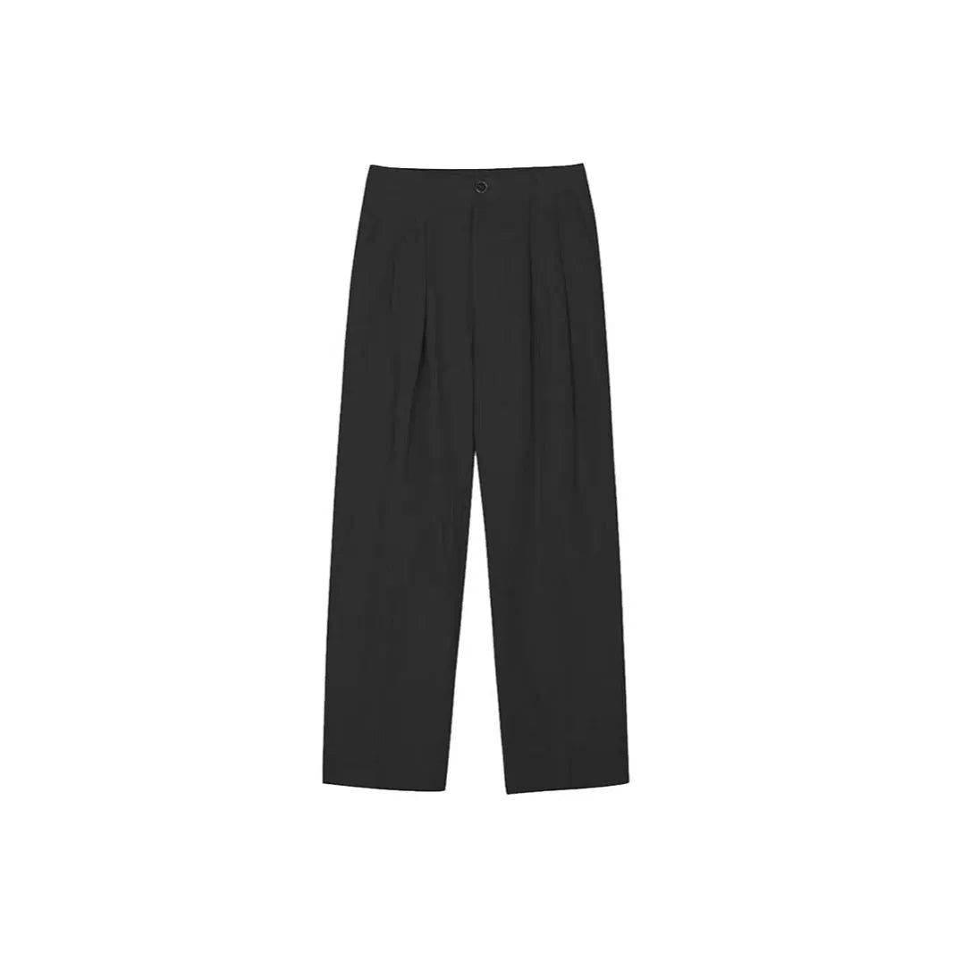 Man wearing loose fit apricot wide-leg cotton linen trousers with a zip fly and straight leg opening.