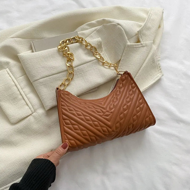 Brown pleated chain baguette shoulder bag with adjustable strap and soft carry handle