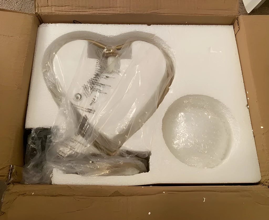 White heart shaped LED table lamp with transparent shade on a wooden surface.