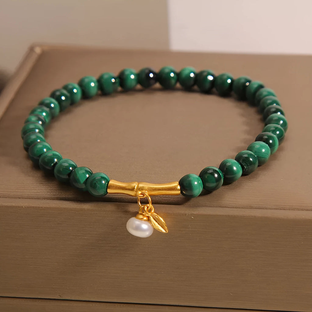 Women's white crystal bracelet with bamboo charm on adjustable metallic chain showing length between 20-24cm