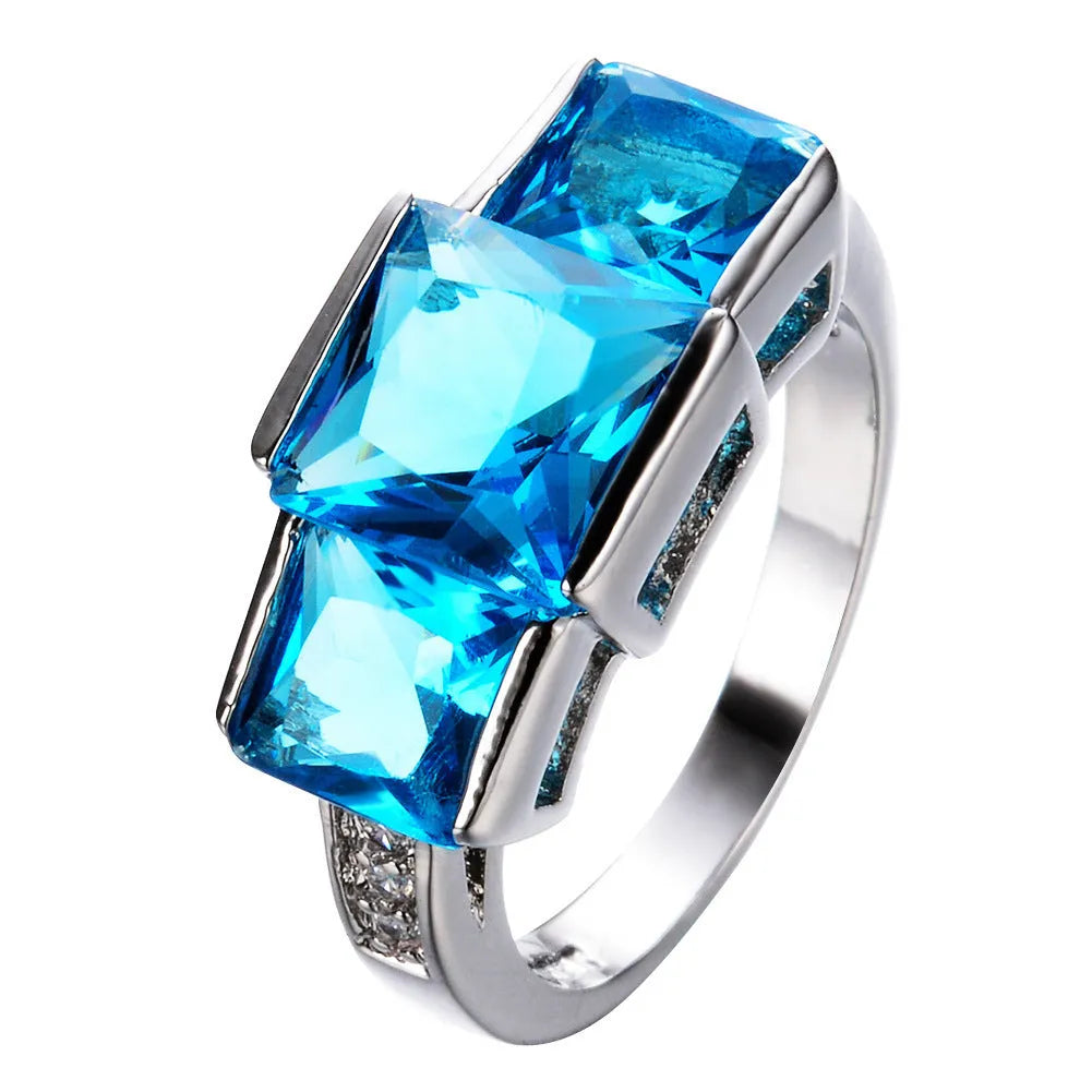 Women's copper electroplated ring in geometric design showing colour options including apple green and sapphire blue