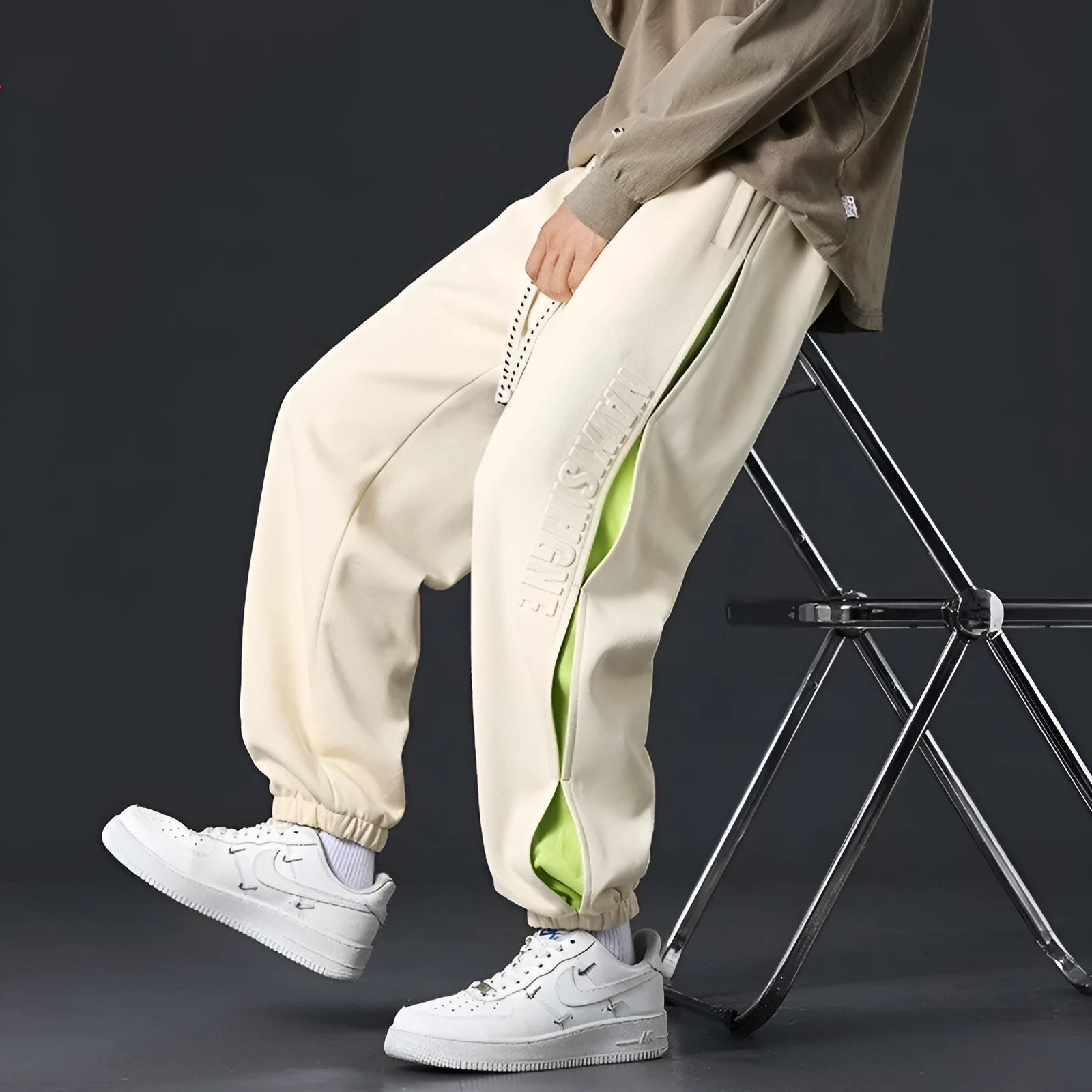 Men's loose-fit ankle banded cotton trousers with stitching detailing and skinny leg opening in grey green colour