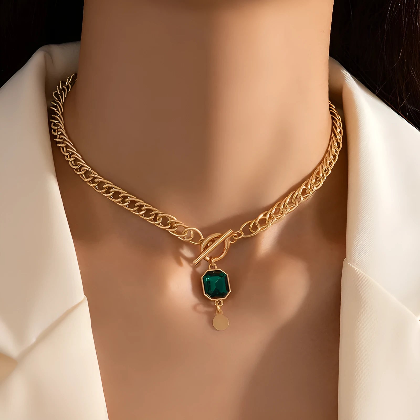 Gold electroplated titanium steel necklace with geometric pendant and emerald zircon stone on Cuban link chain