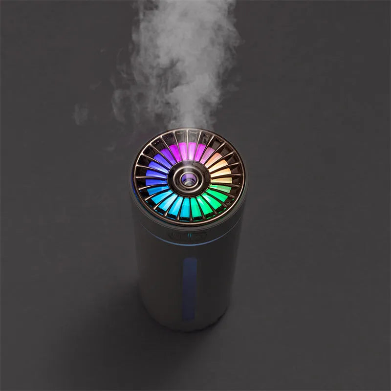 Black portable USB humidifier with colourful LED lights, shown next to a USB cable, suitable for car cup holders.