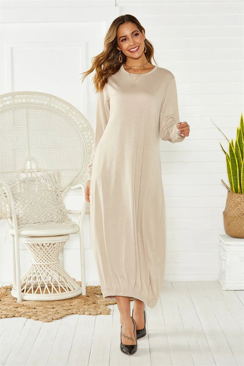 Black lace-up crew neck long lantern dress on a hanger, showing loose fit and lace detail.