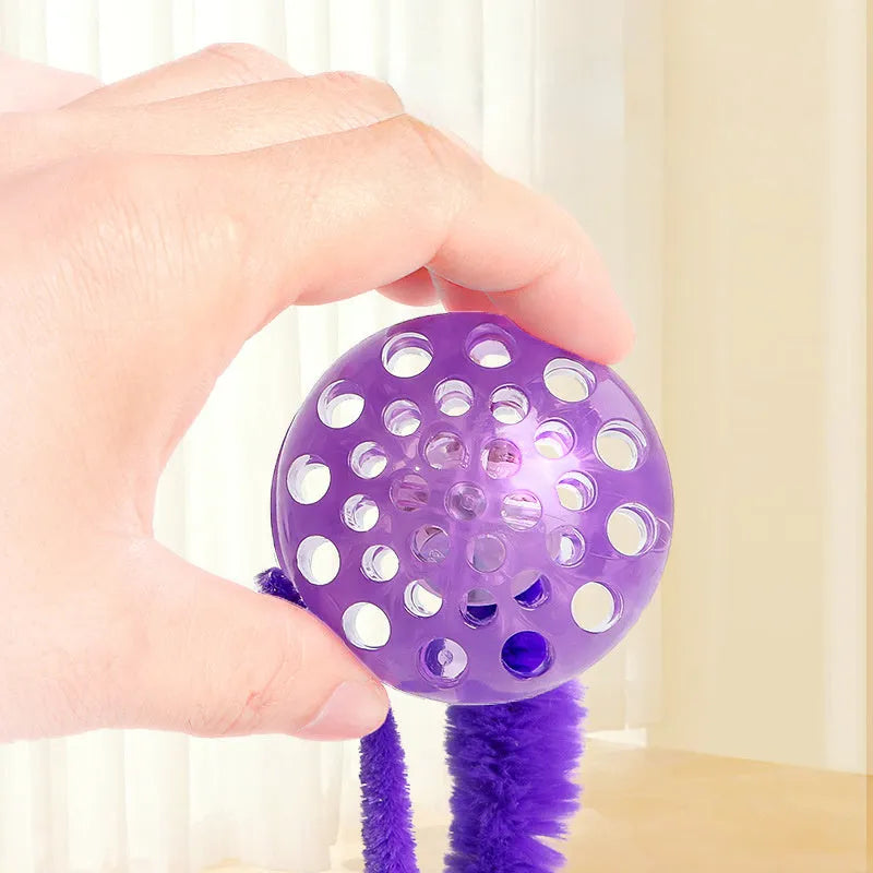 Interactive bouncy ball cat toy with soft plush worm tail in green, pink, or purple colours