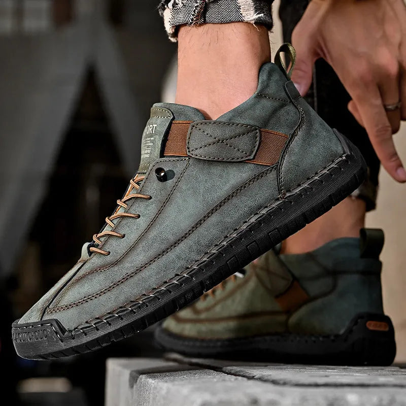 Men's mid-calf black Martin boots with tooling stitching and an elastic band side closure.