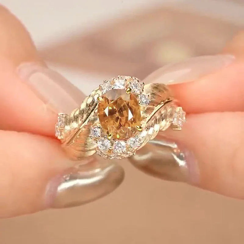Gold-colour copper women's ring with embossed feather pattern and yellow zircon stone