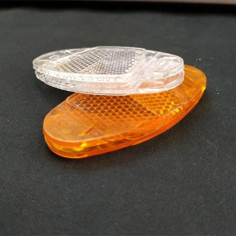 White and yellow plastic bicycle reflector spoke decorations showing 7.2cm length and 3.5cm width dimensions