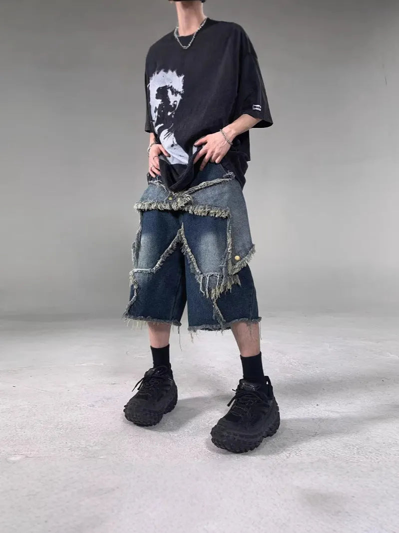 Blue loose-fit men's denim shorts with a frayed hem and a large retro star design on the leg.