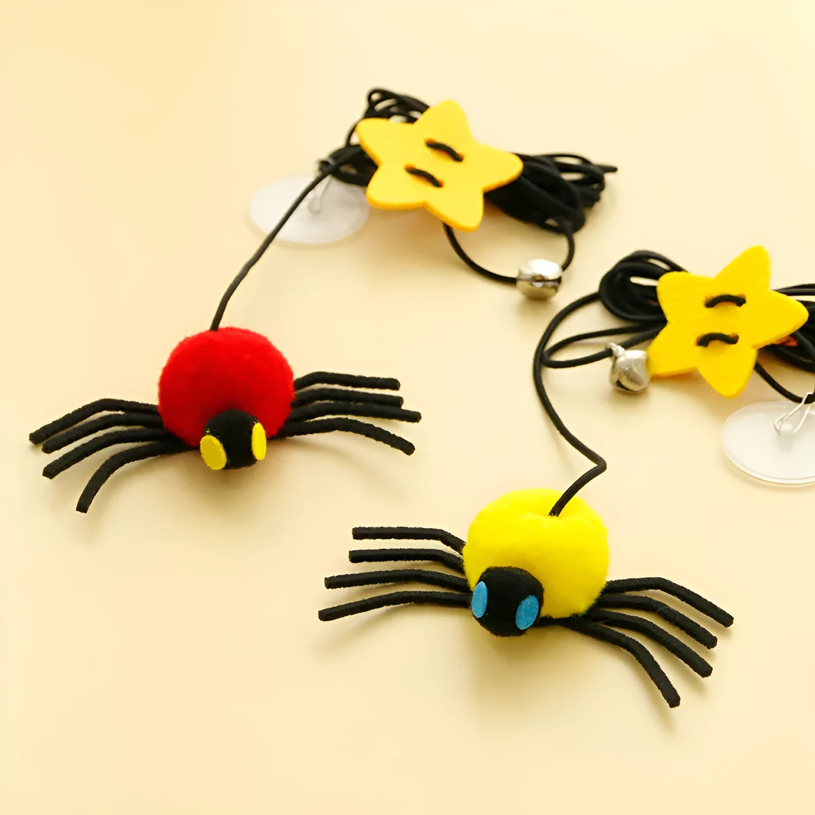 Red cat door hanging toy with swinging elastic rope, feather attachment, and bell spider