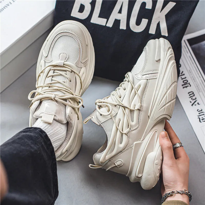 Men's beige low-top lace-up sneaker with mesh upper and platform rubber sole.